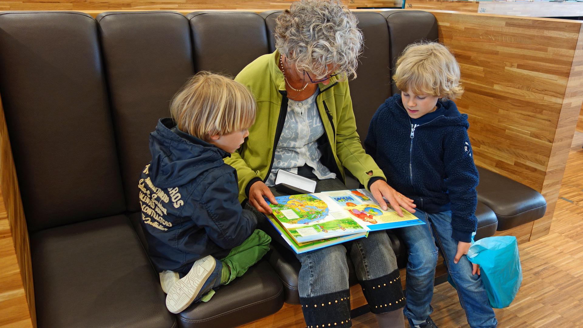 Adult reading with 2 children