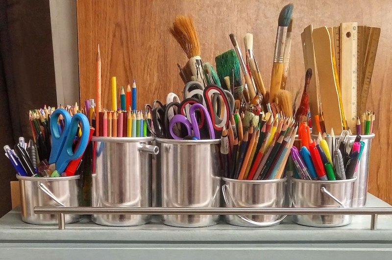 Pens and paintbrushes in pots